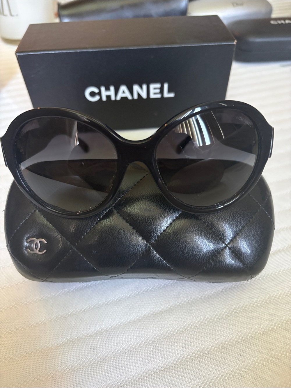 CHANEL Black Oversized Round Women's Sunglasses with iconic bows on each side.